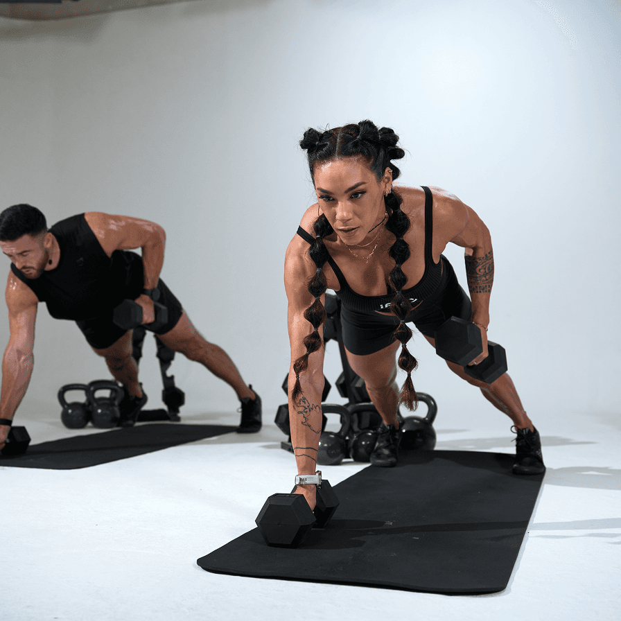Two people performing renegade rows with dumbbells during a strength workout built by Tailor in the iFIT Personal Trainer app